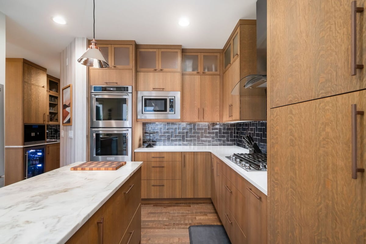 Littleton, CO whole home renovation kitchen with wood cabinets, quartz counters, and stainless appliances by Cillessen Construction