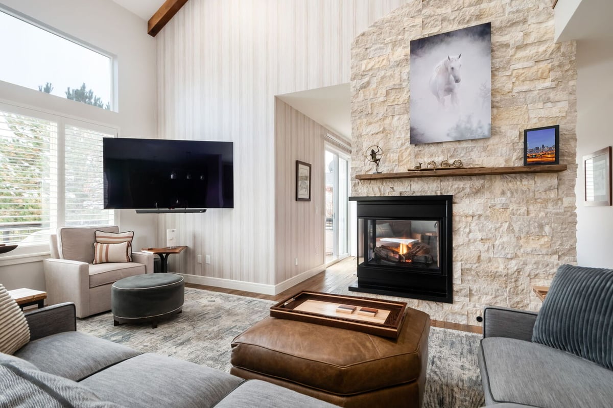 Littleton, CO whole home renovation living room with fireplace, mounted TV, and contemporary seating by Cillessen Construction