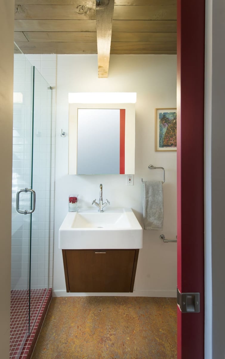 Applewood, CO custom home bathroom with glass shower, floating vanity, and modern finishes by Cillessen Construction