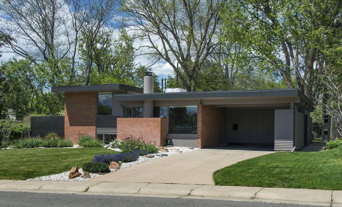 Applewood, CO custom home exterior with brick facade, flat roof, and landscaped yard by Cillessen Construction