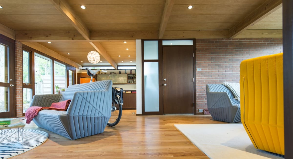 Applewood, CO custom home living area with wood beams, modern furniture, and open layout by Cillessen Construction