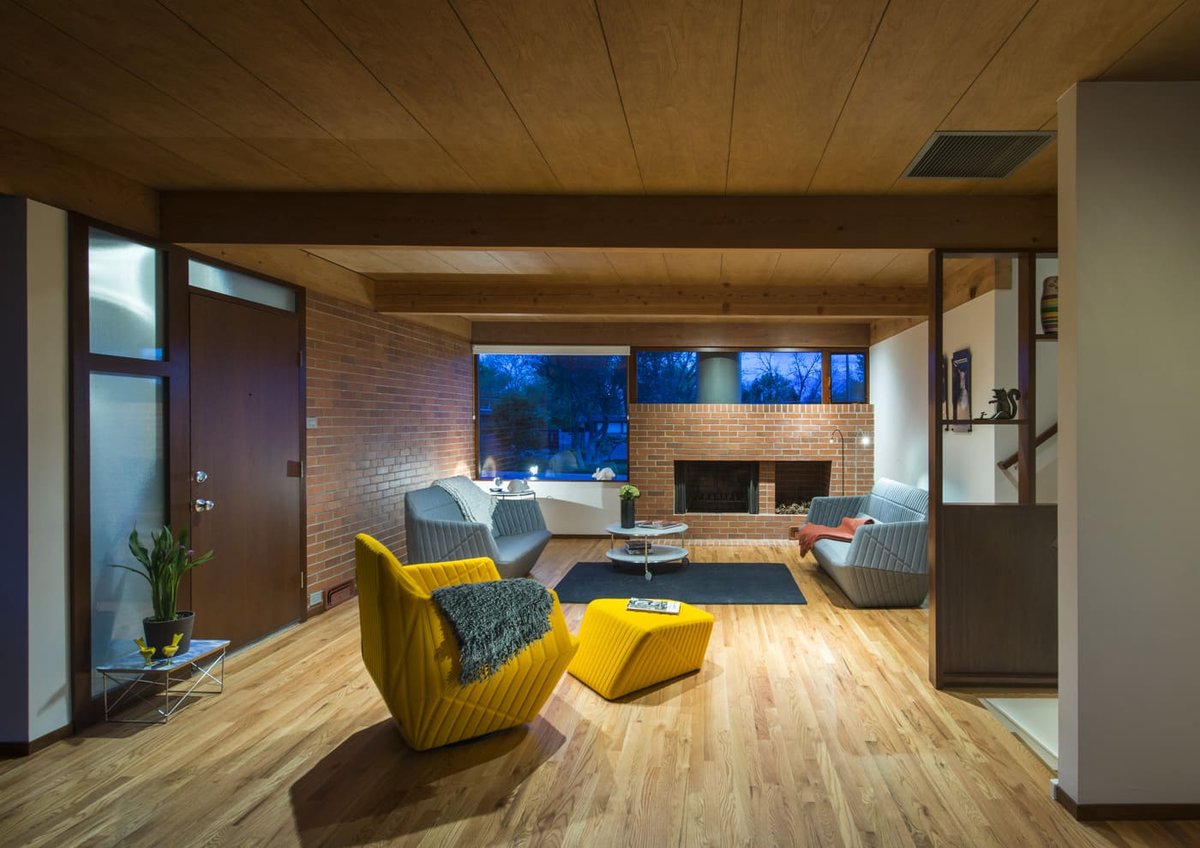 Applewood, CO custom home living room with wood ceiling, brick fireplace, and modern seating by Cillessen Construction