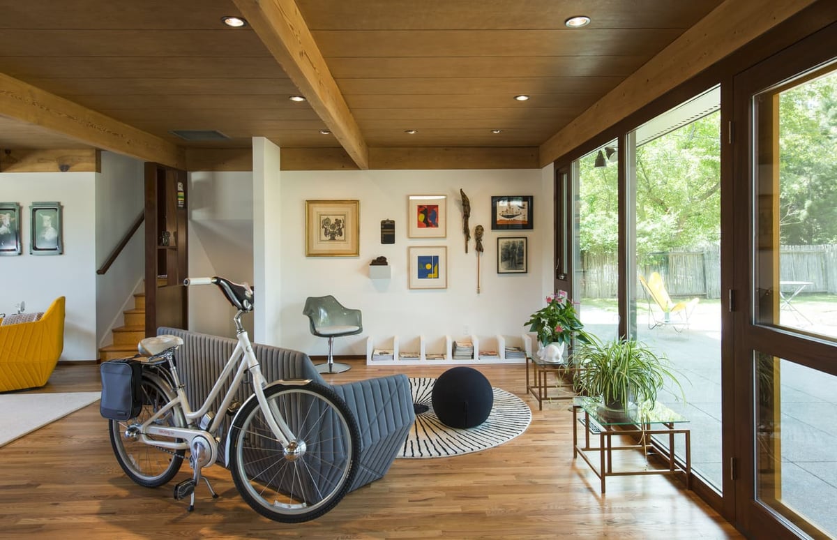 Applewood, CO custom home living space with large windows, wood ceilings, and modern decor by Cillessen Construction