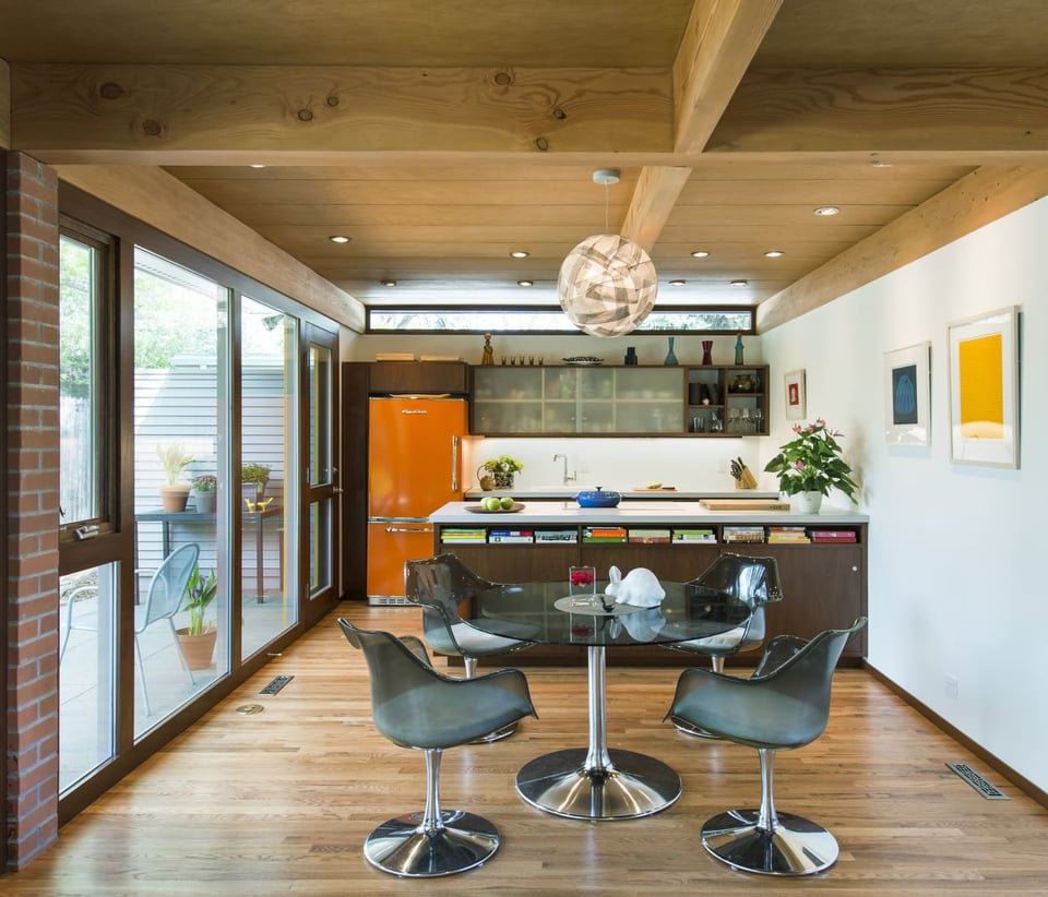 Applewood, CO custom home kitchen with wood ceilings, modern cabinetry, and orange fridge by Cillessen Construction