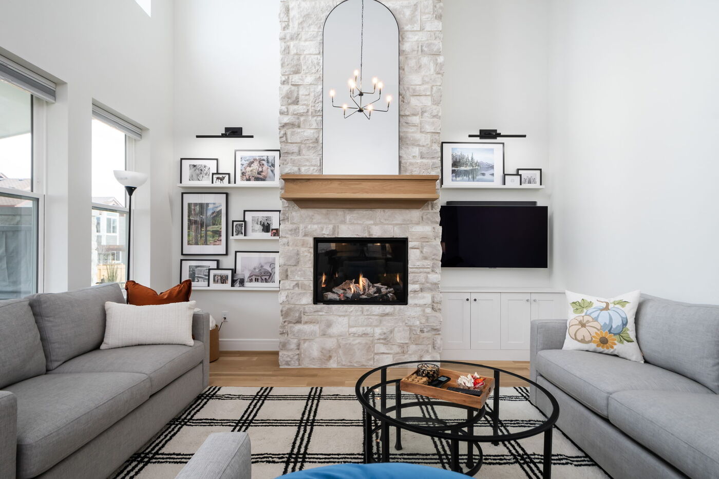 Louisville, CO custom home living room with tall ceilings, fireplace, and modern decor by Cillessen Construction