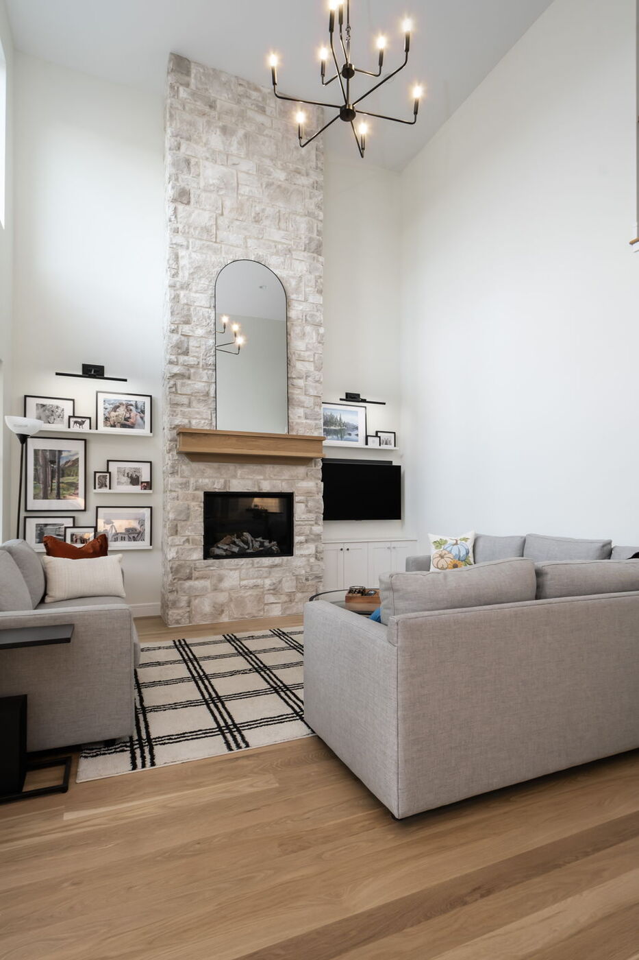 Louisville, CO custom home living room with stone fireplace and modern seating by Cillessen Construction
