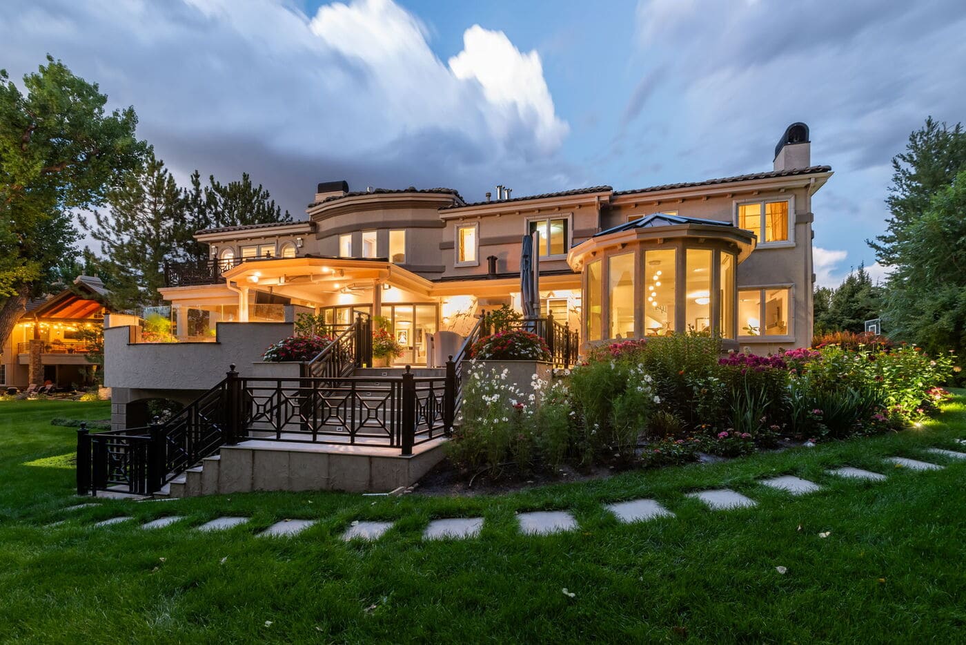 Greenwood Village, CO rear exterior with garden beds and illuminated patio, by Cillessen Construction